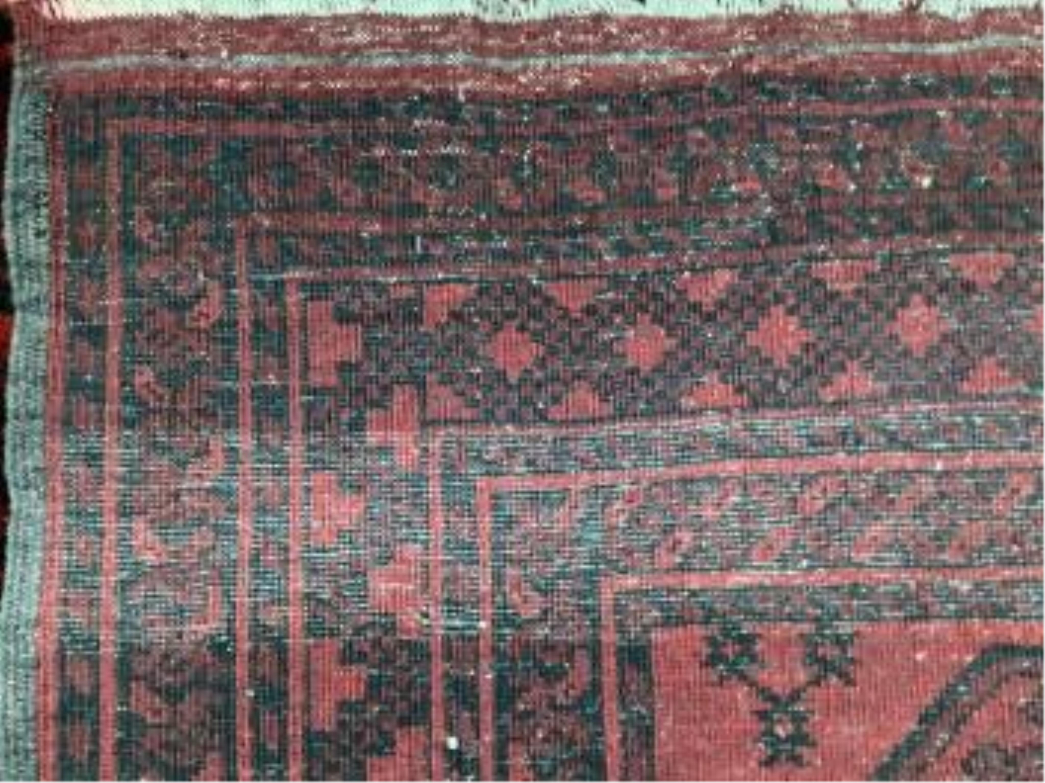 Two Afghan red ground rugs, largest 170 x 120cm. Condition - fair